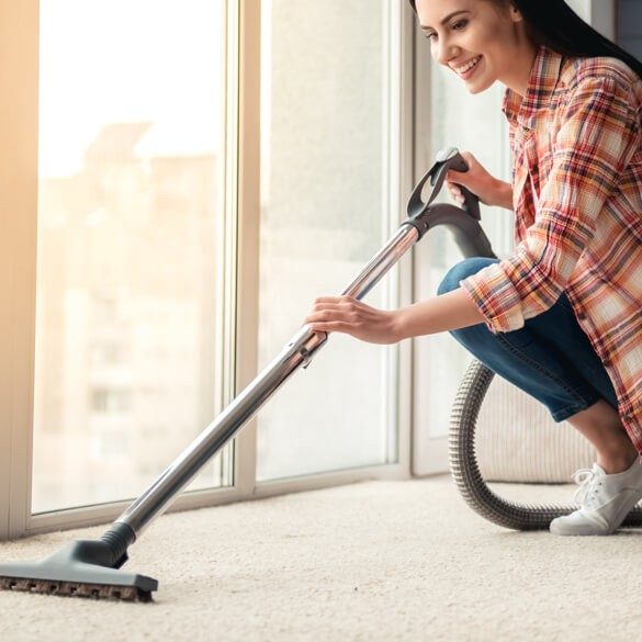 woman vacuuming carpet | AJ Rose Carpets