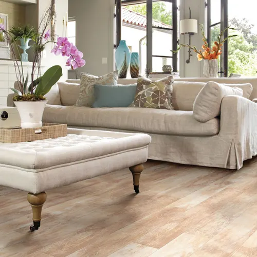 Luxury laminate flooring in a living with a couch and middle table by AJ Rose Needham, MA - Lynnfield, MA - Natick, MA - Burlington, MA.